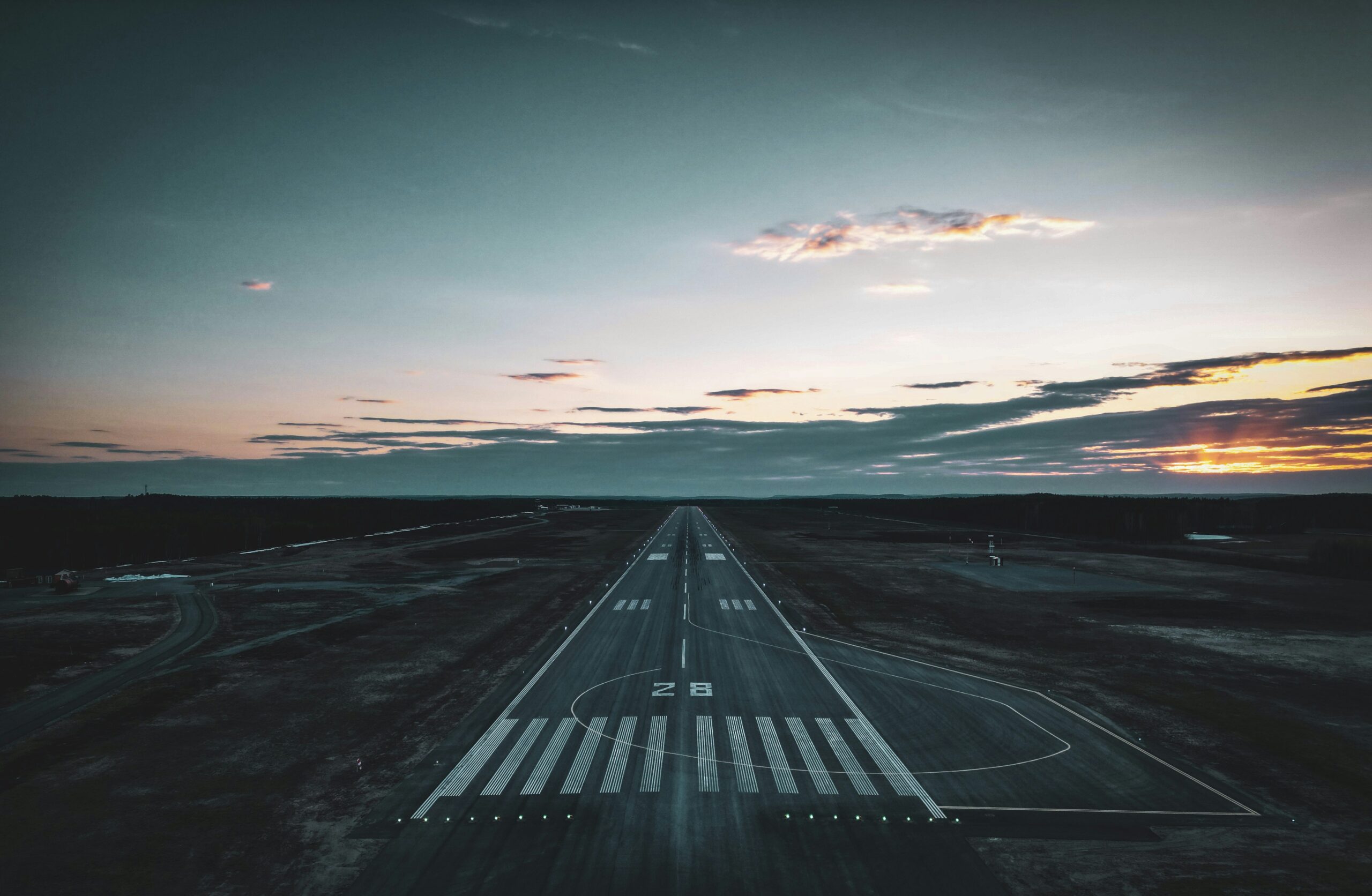 Airplane on runway at golden hour, symbolizing Dubai South and Al Maktoum Airport growth