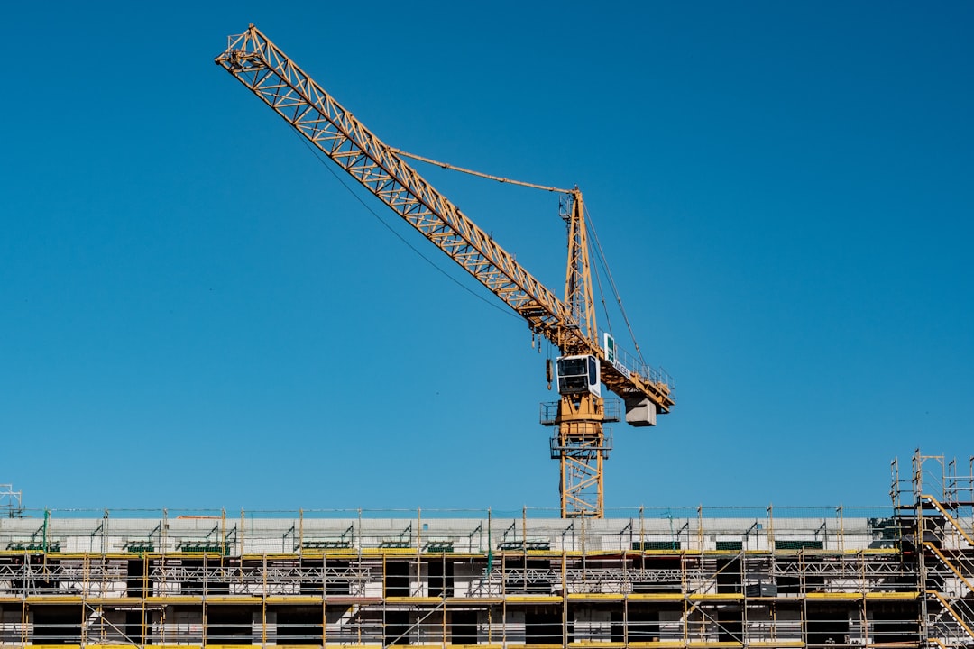 Construction crane against blue sky, representing off-plan development in Dubai