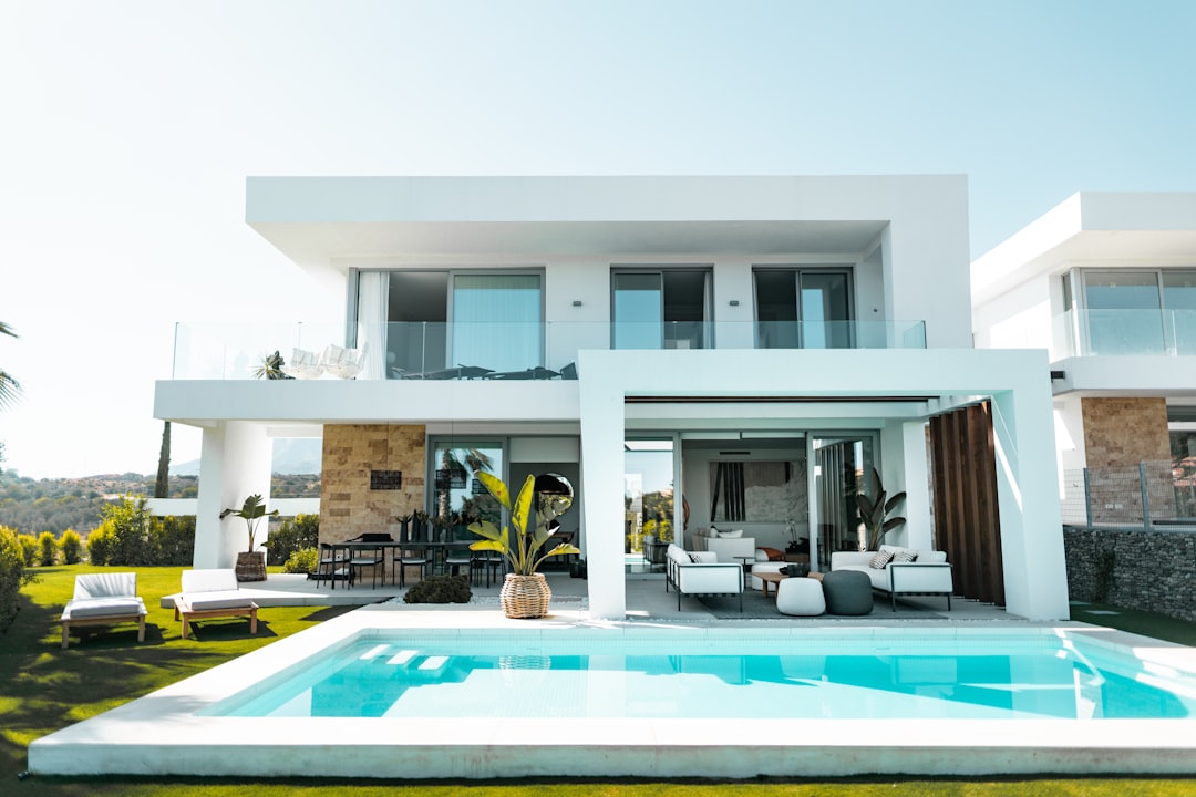 Modern white luxury villa with swimming pool and outdoor lounge